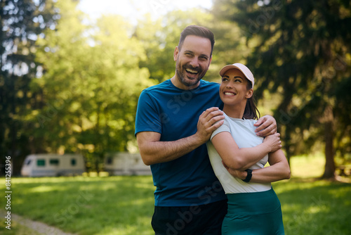 Portrait of happy athletic couple in park.