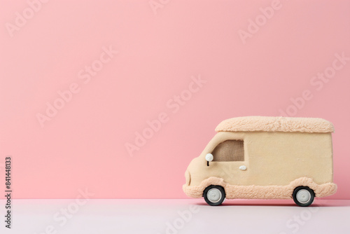 Toy truck made of plush on a pink background with copy space. Plushie delivery van.