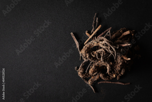 A pile of Dry Organic Nirgundi (Vitex negundo) roots, isolated on a black background. Top view