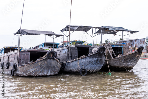 Photo of the front of three of the boats at the floating market in the mekong delta in Vietnam.