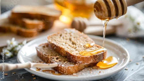 toster bread with honey on the white plate on breackfast table