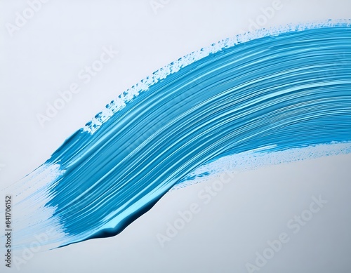 Brushstroke of light blue tempera or acrylic paint on a light grey background.