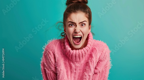 Photo of lovely young girl scream wear pink pullover isolated on teal color background 