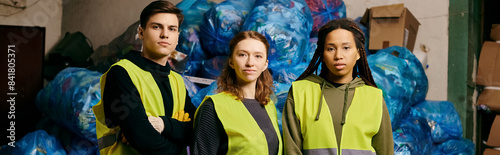 A diverse group of young volunteers in gloves and safety vests stand together, sorting waste with eco-conscious intent.