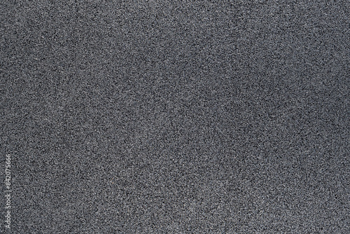 surface of a rubber hydro pad made from recycled car tires. This new modern building material for street roads and playground. a close-up texture-filled frame.