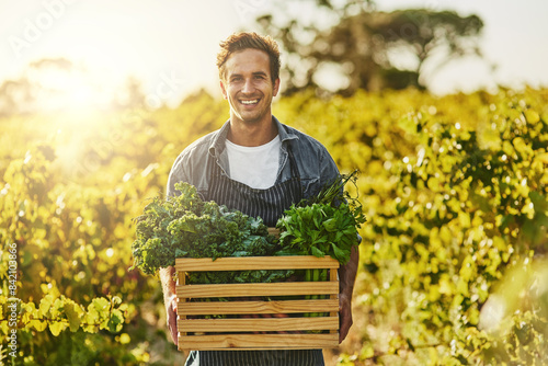 Sustainable, farming and portrait of man with box for vegetables, production and harvest in nature. Smile, farmer and container with organic produce for agro business, ngo and growth in Australia