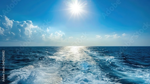 Ferry sailing on the tranquil ocean waves under the bright sun