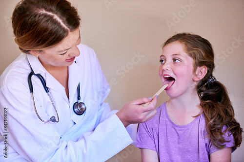 Depressor, child and doctor check mouth for wellness, test or healthcare of people in medical hospital. Kid, pediatrician or throat exam of girl for tongue, tonsils or ent otolaryngology with patient