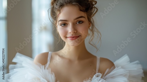 Elegant and minimalistic portrait of a smiling ballerina in a tutu, isolated on a white background. The bright and light design highlights the grace and joy of ballet. 