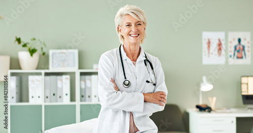 Hospital, crossed arms and portrait of mature doctor with stethoscope for medical career, support and health. Clinic, healthcare and professional woman for cardiology, pulmonary service and wellness