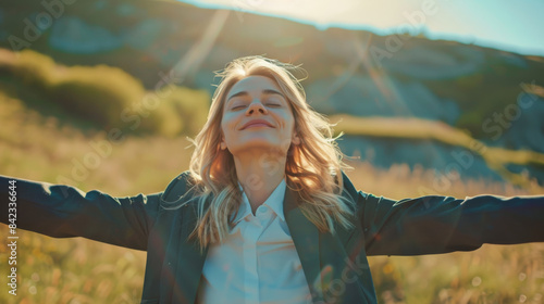 Portrait of a free happy blonde hair caucasian businesswoman with open arms enjoying life with nature background , young joyful business female in suit with good mental health