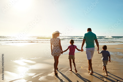 Happy family, walking and holding hands at beach in summer for relax, travel and holiday in Miami. Children, parents and people at ocean with back for vacation, trust and bonding together by water
