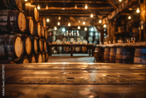 An elegant, polished oak tasting table in the foreground with a blurred background of a high-end whisky distillery. The background includes rows of oak barrels.