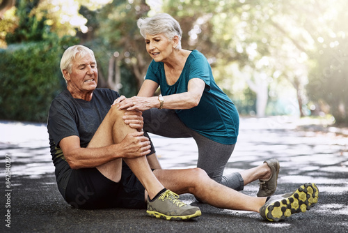 Park, old couple and knee pain with injury, exercise and ache with inflammation, broken and support. Accident, arthritis and senior man with woman, workout and muscle tension with fibromyalgia