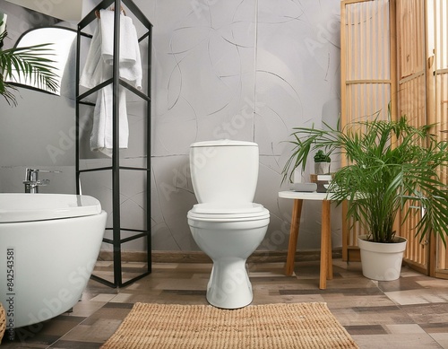 Stylish interior of modern bathroom with toilet bowl