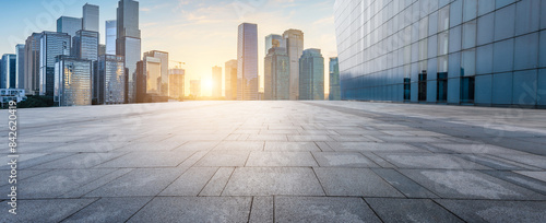 Empty square floors with modern city buildings scenery at sunrise. Panoramic view.