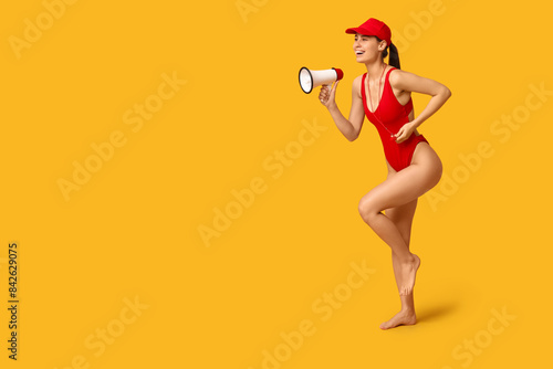 Female lifeguard with megaphone and whistle running on yellow background