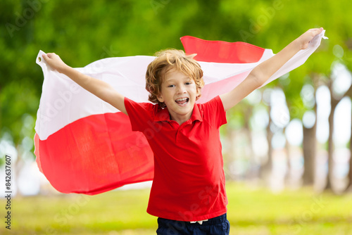 Child running with Poland flag. Little Polish fan