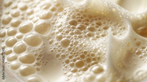 A macro shot displaying the detailed frothiness and bubbles of milk, showcasing texture and creamy color