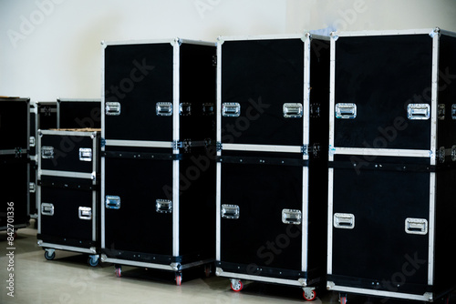 Flightcase of concert music and video equipment stacked behind the stage 