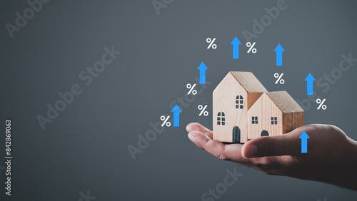 house or building or land value property tax, local development tax concept. Word tax, home model on hand, depicts ad valorem tax on value of a property.