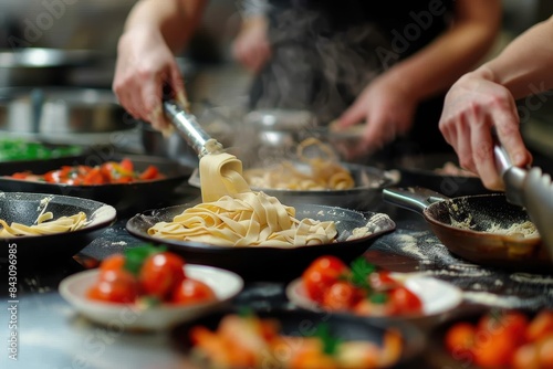 Chefs are making fresh pasta, using raw ingredients and various utensils on a kitchen work surface