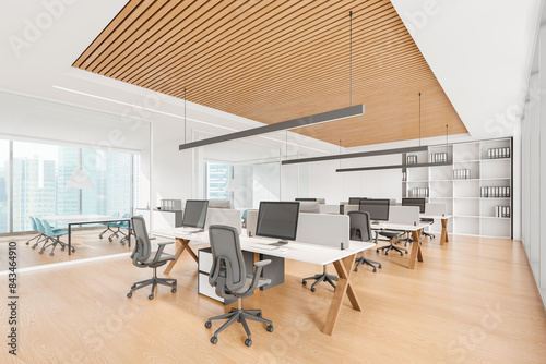 Modern open office space with workstations, wood panel ceiling, and large windows. Light design. Concept of contemporary work environment. 3D Rendering