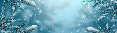 Winter scene of snow-covered branches with falling snowflakes against a blue background creating a serene and festive atmosphere.
