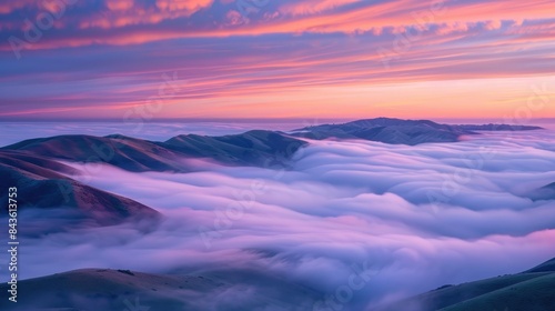 Beautiful sunrise landscape with hilltops rising out of the fog