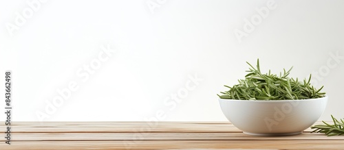 Bowl of dry tarragon on white wooden table Space for text. copy space available