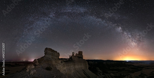 Panoramic at night with milky way of the ruins of the Sora castle in Zaragoza, silhouetted against a cloudless sky