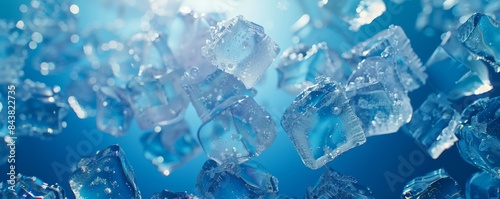 Ice cubes floating in water with air bubbles on blue background