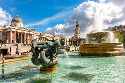 Fountain on Trafalgar square with National Gallery at background, London, UK