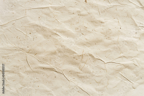 High resolution vintage textured handmade paper background with natural crinkled fibers in beige. Perfect for eco-friendly organic craft design templates