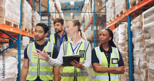 Woman, tablet and group with walking in warehouse with shelf, package or stock check with diversity. People, men and team with discussion for logistics, inventory or cargo for supply chain at factory