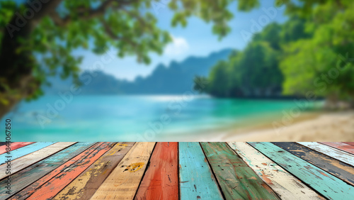 Blurred background of a tropical sand beach with palm trees in summer, providing a perfect setting for a wooden table used for summer product displays.