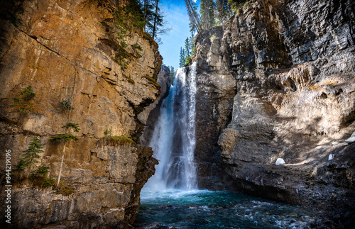 Waterfall landscape in Johnston Canyon in Banff National Park in Alberta Canada on a sunny summer day.