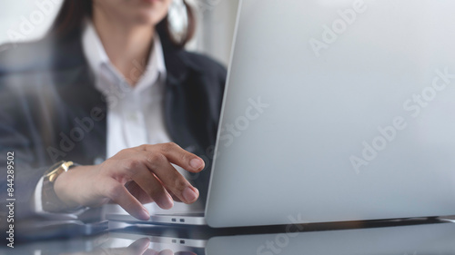 Business woman searching the information, surfing the internet on laptop computer at office, close up. Businesswoman online working, social networking via computer device