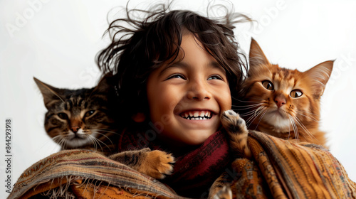 A portrait of a South Asian child with bright eyes, laughing as their playful dog licks their face. The child holds up a hand for a high five, with a cat playfully batting at their leg. Trendy