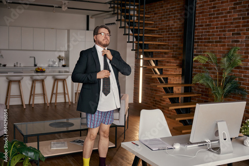 Funny businessman preparing for online work wearing necktie