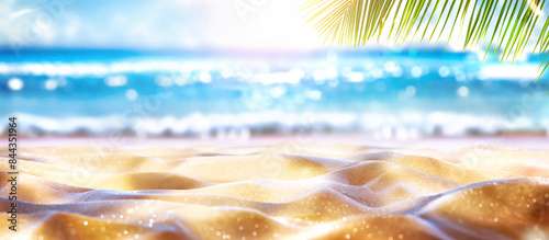 sandy beach with palm leaves and blue waves blurred background; summer vacation in the natural beauty of a tropical paradise