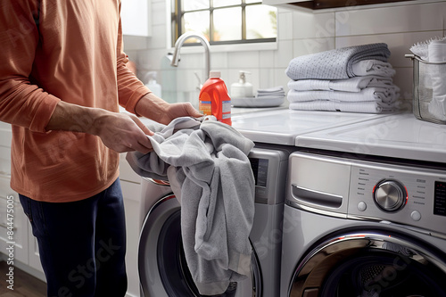 close up of Man doing laundry in washing machine at home