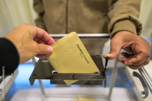 View of a person cast his ballot as he votes for the European elections at a polling station in France