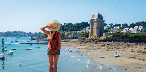 Saint Malo, Solidor tower in Brittany- Woman tourist enjoying beautiful view of tower and atlantic ocean- Travel in France