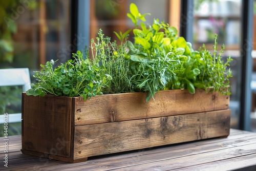 Detailed image showcasing a variety of aromatic herbs growing in a handcrafted wooden planter box on a wooden surface