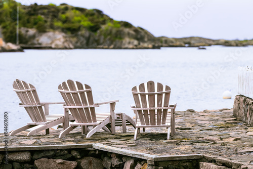 Wooden chairs with view by the fjord. Concept: cold travel destination travel. Loshavn, Farsund, Norway
