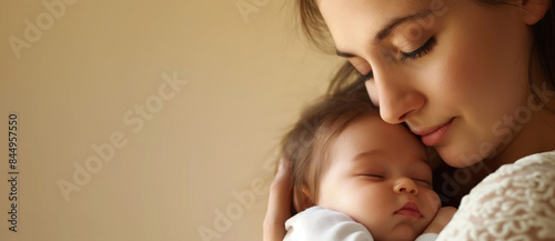 Mother tenderly embraces her sleeping baby girl, radiating love and care in a peaceful, happy scene of pure tenderness and connection