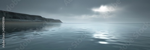 A wide shot of a calm sea with a distant cliff and a misty sky