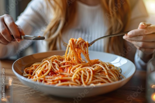 Close-up of a person enjoying a delicious plate of spaghetti. Perfect for food blogs and recipe websites. Captures the essence of casual dining and pasta lovers. Generative AI