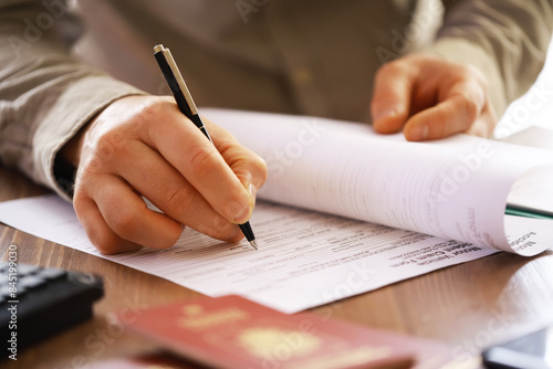 Businessman Signing Important Document - Close-up of Hand with Pen Signing Paperwork